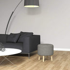 Light grey round storage ottoman with fabric seat and wooden legs