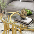 Gold round nesting table pair with clear tempered glass top and steel slatted sides