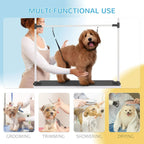 Pet grooming stand with black rubber top and hanging loops; dog on table with handler