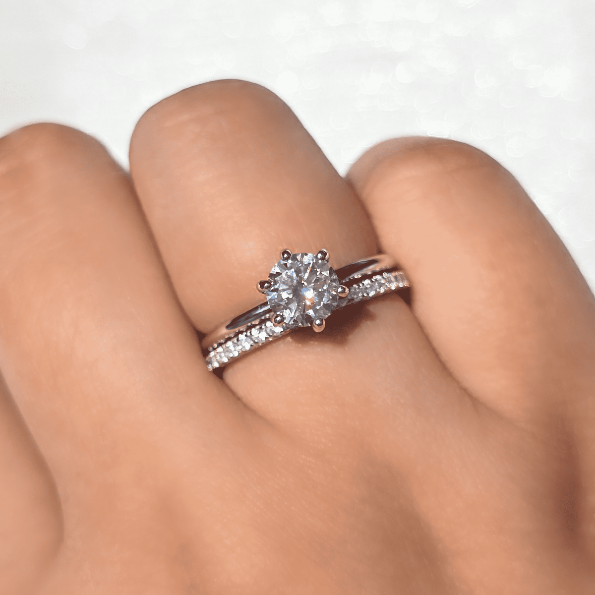 Sterling silver eternity ring with round clear stone and pavé band