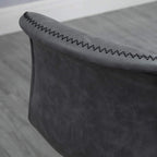 Close-up of dark grey bar stool armrest edge with zigzag stitched trim