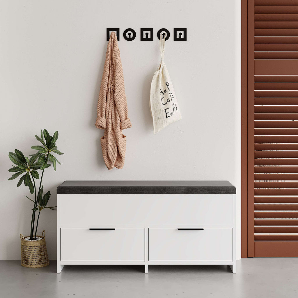 White shoe storage bench with dark cushioned top and two front drawers