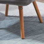 Grey accent chair with light wood legs and round metal glides