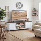 White farmhouse TV console with dark top and built-in open shelves and cabinets.