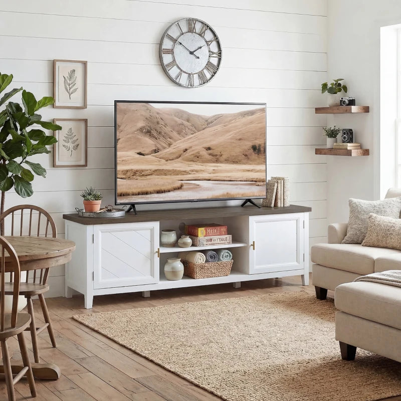 White farmhouse TV console with dark top and built-in open shelves and cabinets.