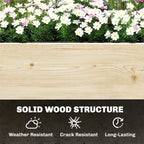 Wood raised planter wall with white flowers along the top edge