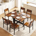 Rustic brown drop-leaf dining table with dark chairs arranged around it