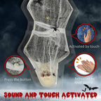 Close-up of hanging grey mummy with spider web wrap and small glowing eyes