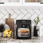 Black air fryer oven on kitchen counter with transparent front cooking door