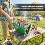 Green charcoal BBQ grill with wire cooking grate and food over smoking coals