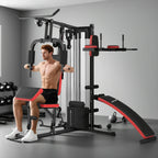 Black multi gym workout station with red bench pads and cable arms over weight stack