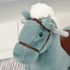 Blue plush rocking horse close-up with blue eye and brown bridle