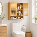 Oak bathroom wall cabinet with louvered doors and open shelf storage