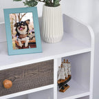 White bookcase with grey drawer front, open shelves, and light wood legs.
