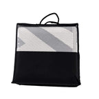 Reversible outdoor rug in carry bag, grey and cream chevron stripe design