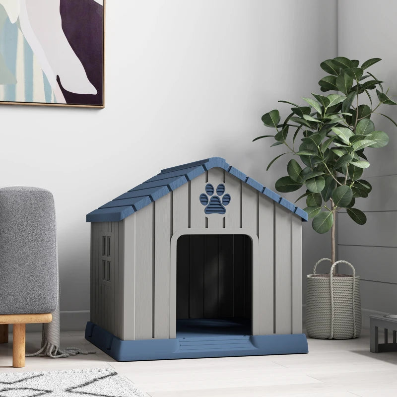 Indoor dog kennel in grey with blue roof; front opening and paw-print panel visible
