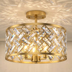 Gold-tone crystal ceiling light close-up with circular metal ring and faceted prisms