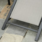 Sun lounger leg and foot pad close-up with grey mesh seat panel on black frame