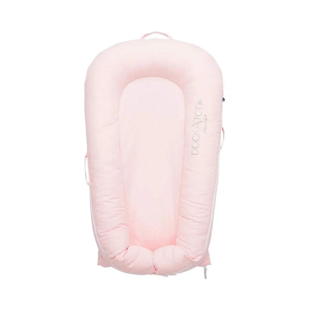 Pink fabric infant dock with raised rim, padded base, and side handles