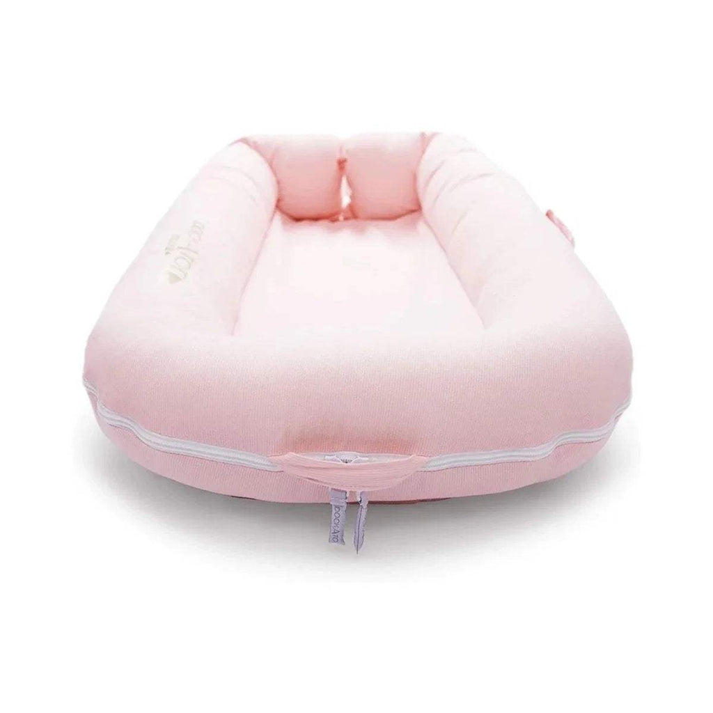 Pink cushioned infant dock with rounded base and central padded interior