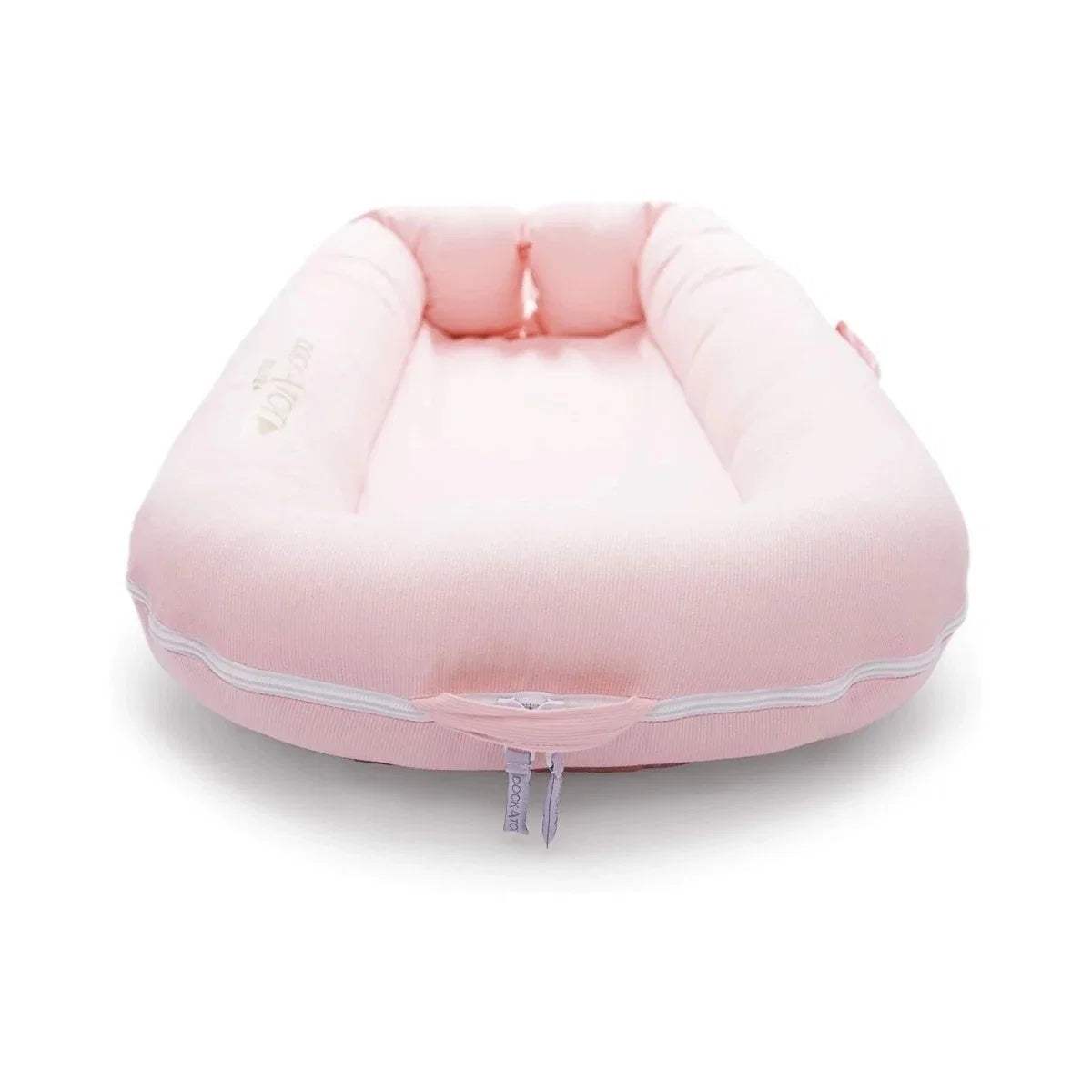 Pink cushioned infant dock with rounded base and central padded interior