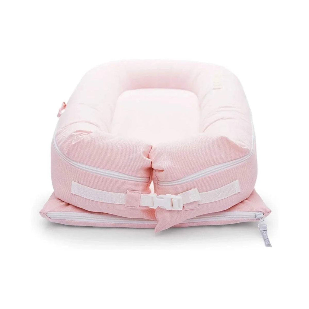 Pink infant dock with front zipper, wide padded rim, and securing straps