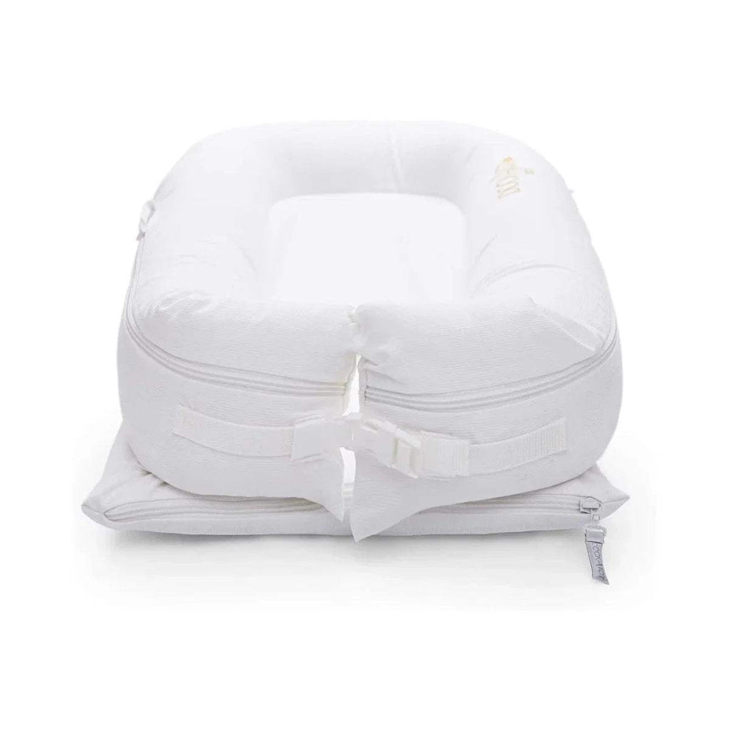 White baby dock insert with fold-over straps and central buckled section
