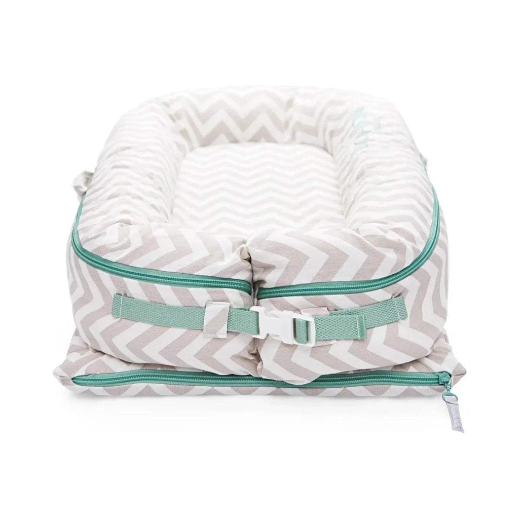 Baby lounger with light chevron fabric, teal zipper edge and side straps