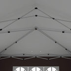 Underside of pop-up gazebo roof with white frame beams and tension points