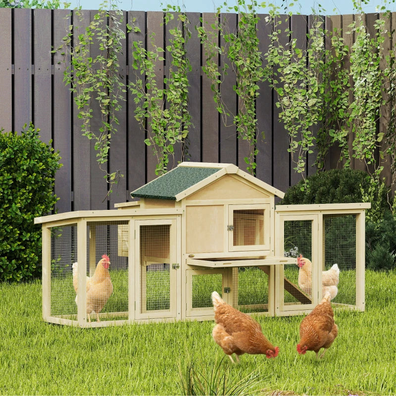 Large wooden chicken coop with green roof and wire mesh walls, with chickens near ramp