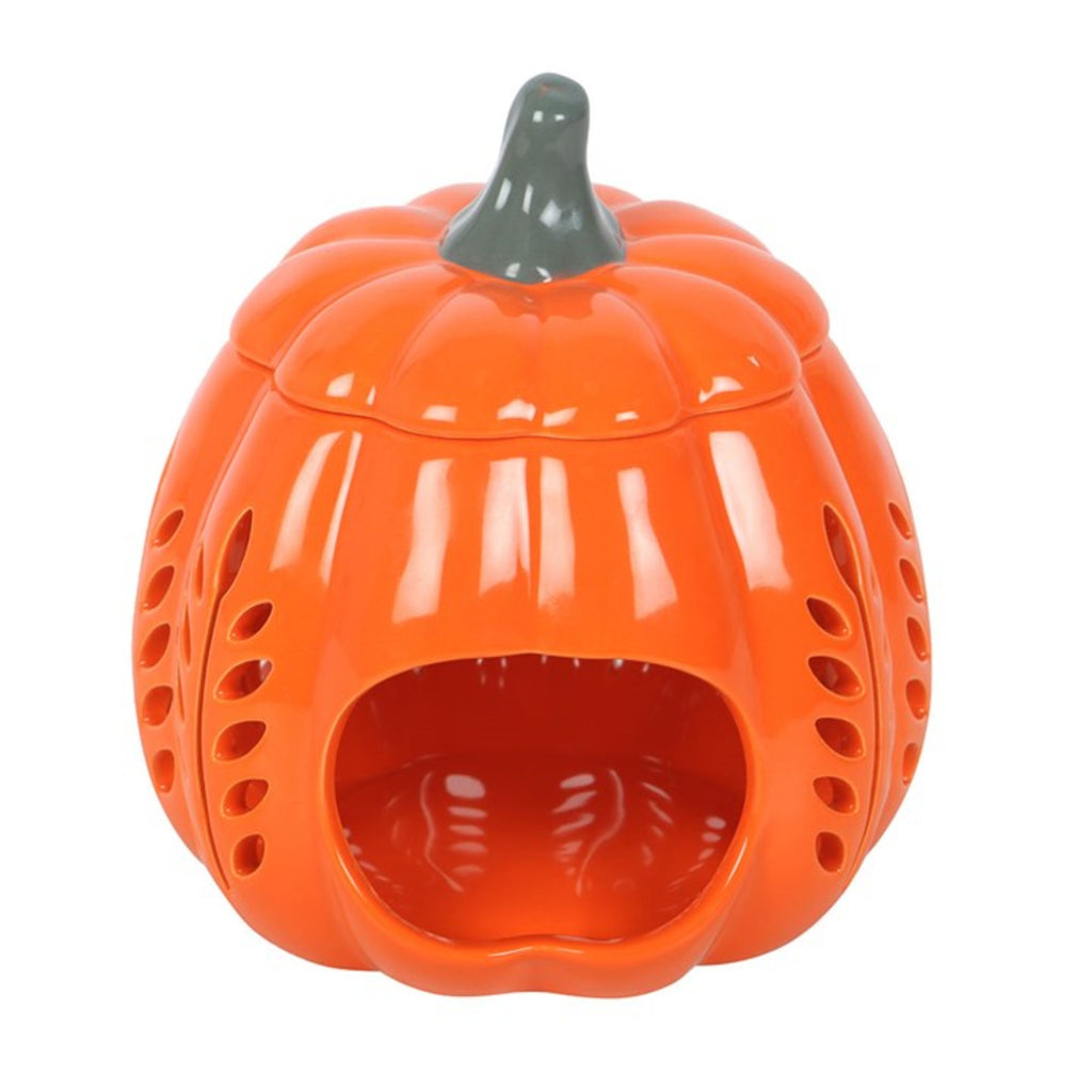 Orange ceramic pumpkin-shaped container with a black lid on a white background