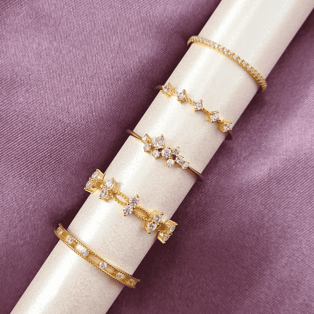 Gold crystal ring trio with openwork marquise stones and round accents on display