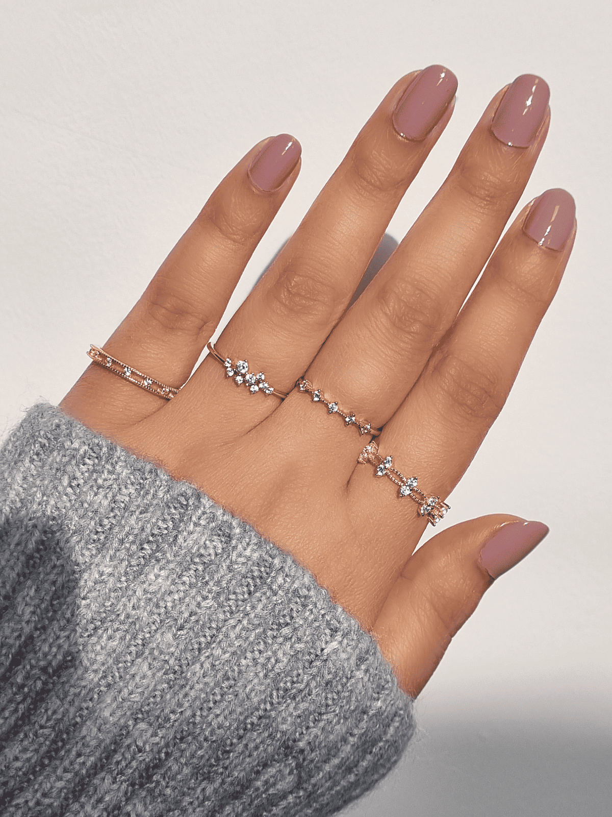 Slim gold crystal ring with evenly spaced small stones on finger
