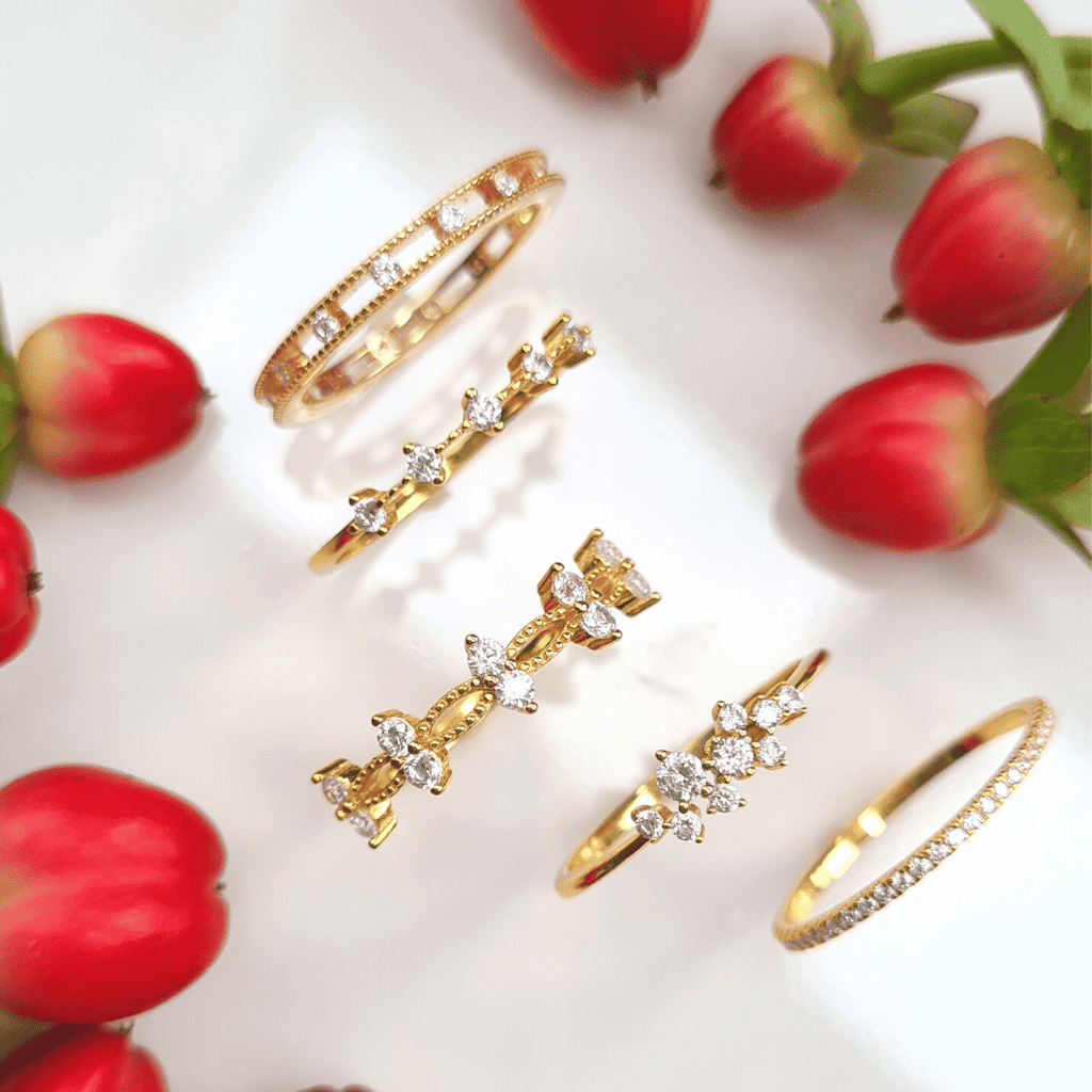 Thin gold full eternity ring with pavé stones, shown with matching gold rings