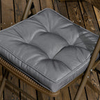 Grey tufted chair seat cushion pad on outdoor chair seat