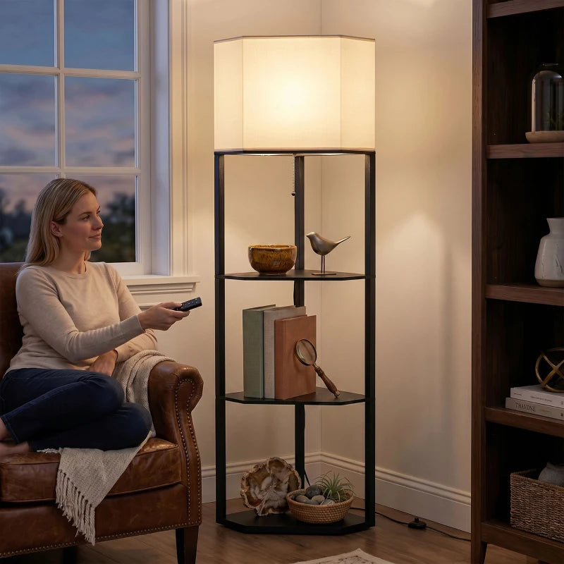 Black standing lamp with lit fabric shade and three glass shelf tiers