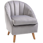 Grey velvet accent armchair with rounded arms, tufted back, and wooden legs