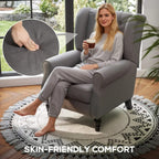 Dark grey wingback armchair with button-tufted back, turned legs, and plush seat