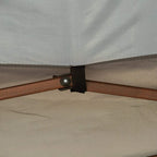 Close-up of gazebo roof corner with strap fastener secured to frame