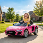 Pink Audi R8 Spyder kids electric ride-on convertible car with child at the wheel
