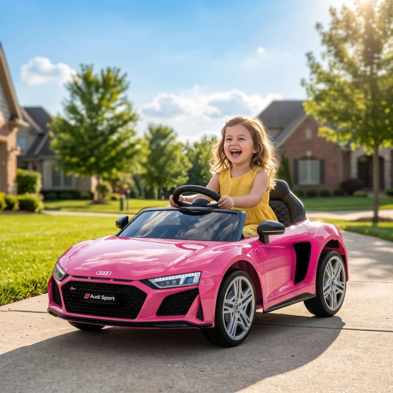 Pink Audi R8 Spyder kids electric ride-on convertible car with child at the wheel