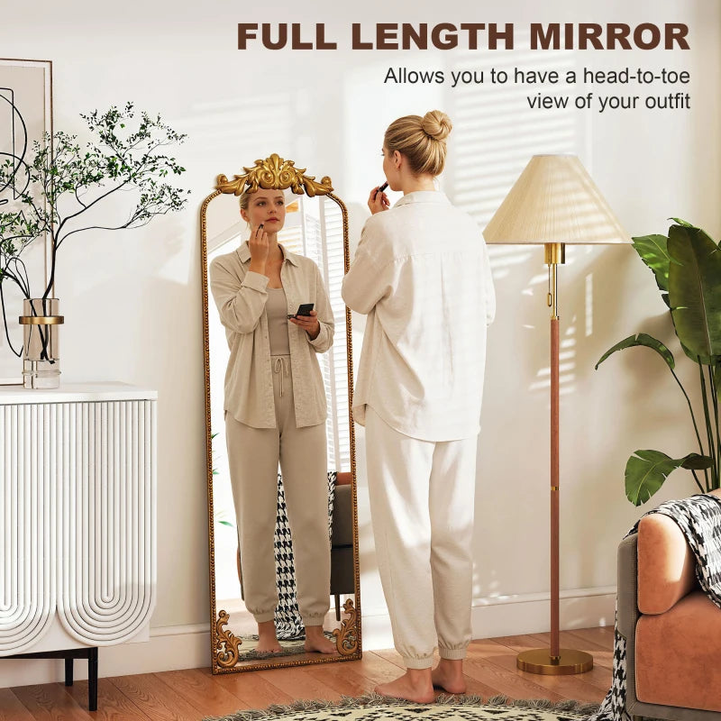 Full length mirror with ornate baroque gold frame, showing a person using it