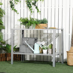 Silver 2-tier plant stand with perforated shelves, holding planters and a watering can.