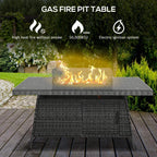 Grey rattan gas fire pit table with flames and glass windscreen, outdoor patio view