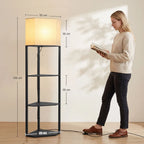 Black standing lamp with fabric shade and three open shelves