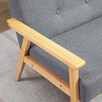 Dark grey upholstered sofa with light wood armrest and tufted back