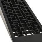 Close-up of black plastic ramp with hexagon grid anti-slip tread pattern