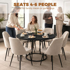 Round black dining table with central conical metal base in dining room