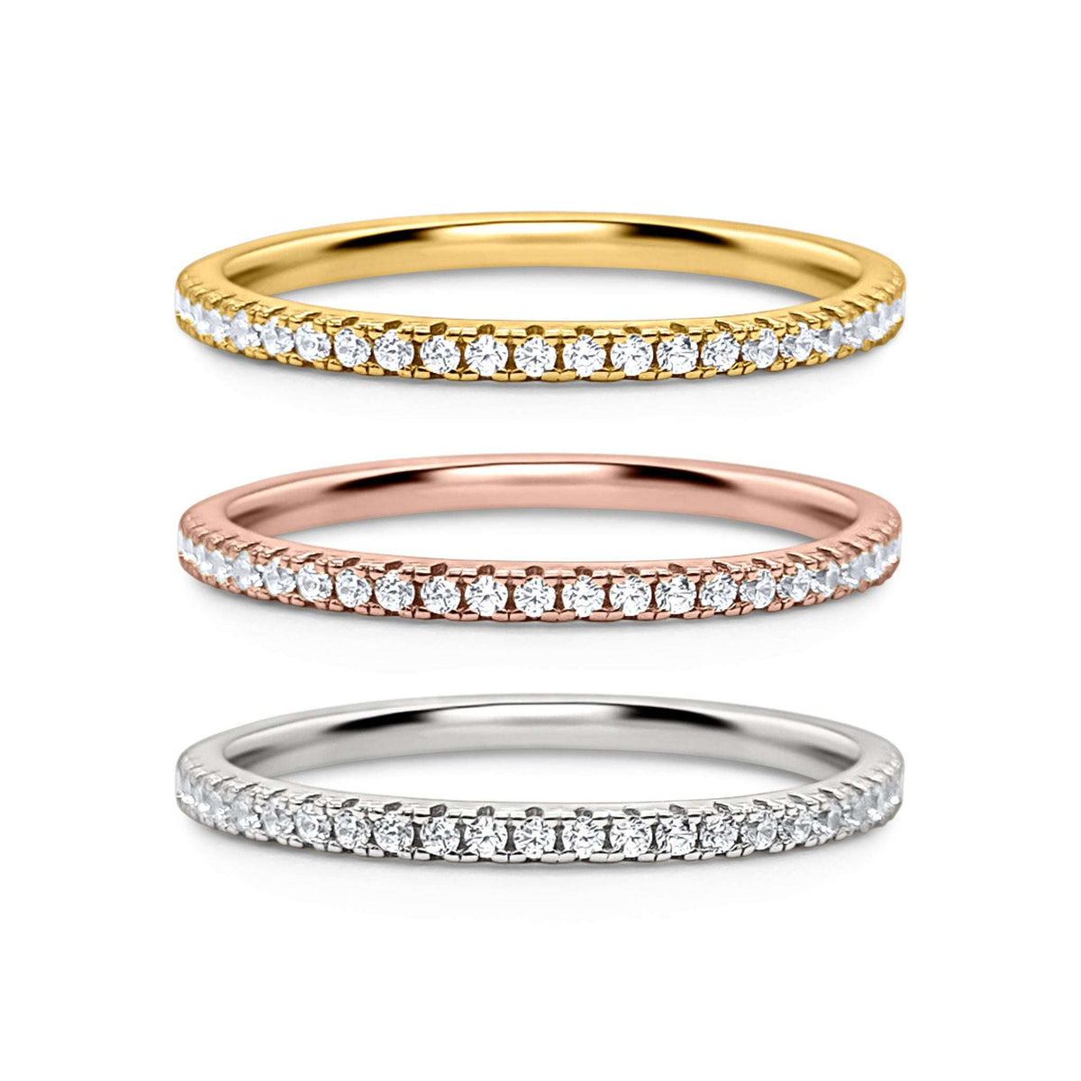 Three eternity stacking rings in yellow gold, rose gold, and silver with pavé stones