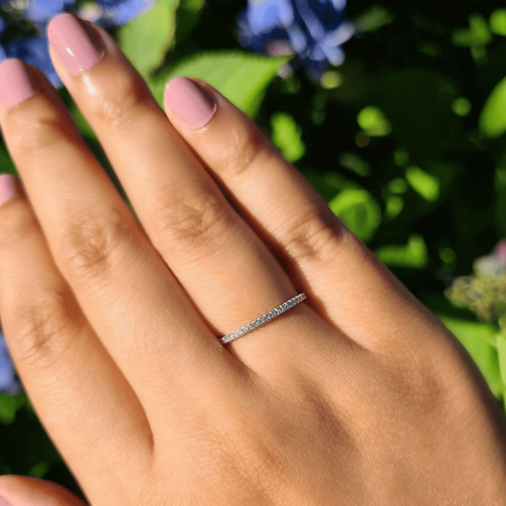 Thin sterling silver eternity ring on a hand